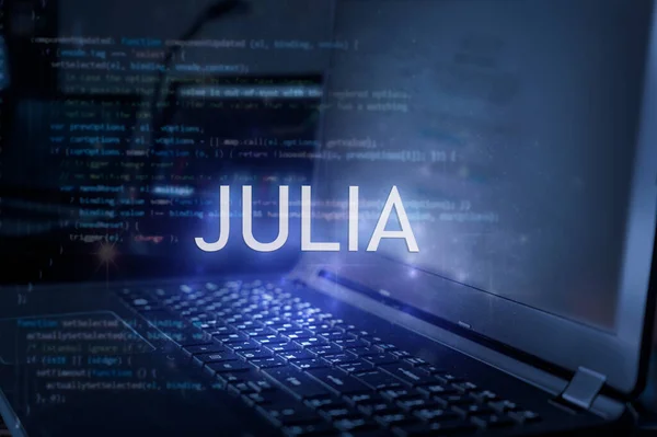 Julia inscription against laptop and code background. Technology concept. Learn programming language.
