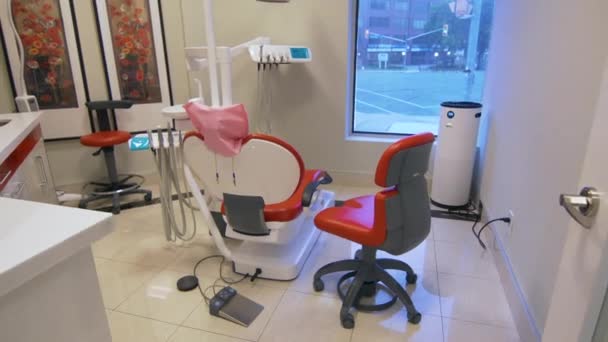 Pohled na profesionální zubařskou místnost s červenými židlemi a dalším stomatologickým vybavením. — Stock video