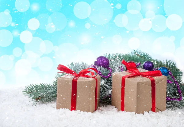 Gift boxes over snow bokeh background — Stock Photo, Image