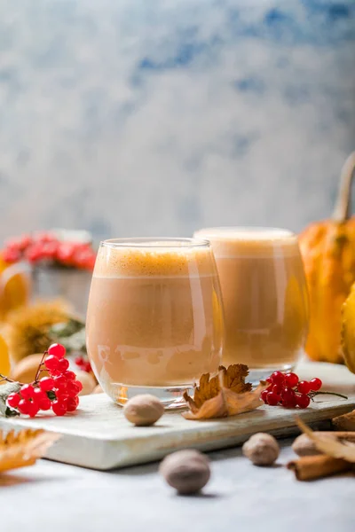 Pumpkin latte in a glasses. Autumn drink for Halloween or Thanksgiving.