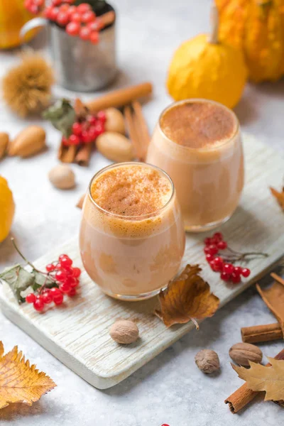 Pumpkin latte in a glasses. Autumn drink for Halloween or Thanksgiving.