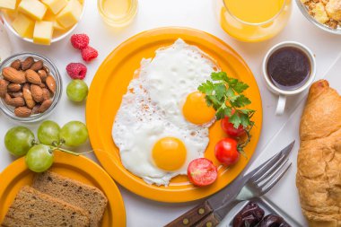 Sunny Side ile ev yapımı kahvaltı kızarmış yumurtalı kruvasan tostu kahve, sebze ve portakal suyu fotokopi alanı ile birlikte. Arka plan için nefis ev yapımı Amerikan kahvaltı konsepti