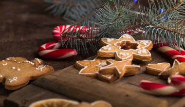 Tahta masa üzerinde karizma süsleri olan zencefilli kurabiye.