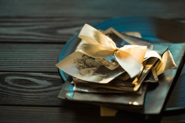 Fotokopi alanı olan turkuaz ahşap arka planda aile fotoğrafı kartı. Ahşap zemin üzerine eski kitap ve kitap yığını