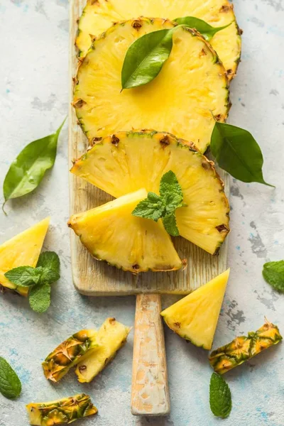 Gri arkaplanda dilimlenmiş olgun ananas