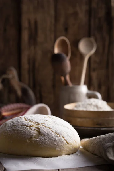 stock image Fresh homemade bread on a dark background, with flax seeds on whole wheat flour. French bread round shape. Bread baking. Unleavened bread