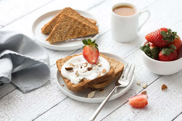 烤面包 奶油奶酪 杏仁和咖啡放在旧木桌上 春食的概念 简朴的早餐静物画 — 图库照片