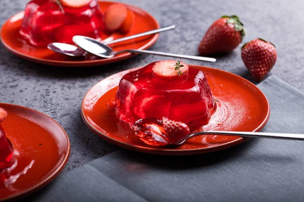 Jelly. Summer dessert with fruit jelly and fresh strawberry.