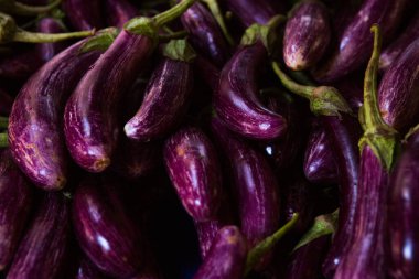 fresh eggplants on a market stall