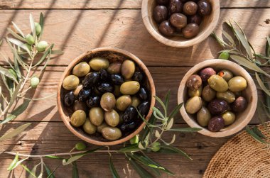 bowls with different kind of olives, green and black kalamata olives with olive oil 