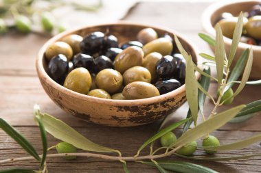 bowls with different kind of olives, green and black kalamata olives with olive oil 