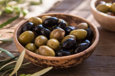 bowls with different kind of olives, green and black kalamata olives with olive oil 