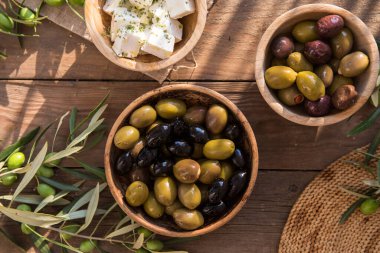 bowls with different kind of olives, green and black kalamata olives with olive oil 