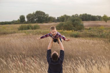 Happy family. Dad and son playing and embracing the outdoors. Father's day 
