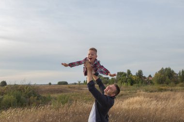 Happy family. Dad and son playing and embracing the outdoors. Father's day 