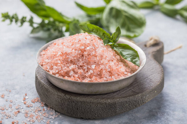 Himalayan pink salt crystals with white salt on wooden spoon, scrub spa therapy, cooking healthy ingredient.