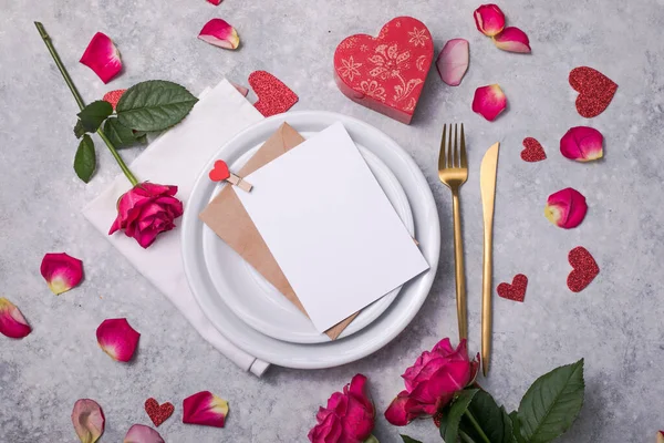 Valentines dinner with table place setting  hearts decoration, rose for valentines days dinner. View from above.