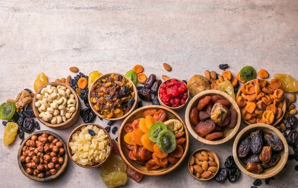 Dried fruits and nuts mix in a wooden bowl. Assortment of candied fruits. Judaic holiday Tu Bishvat. Copy space