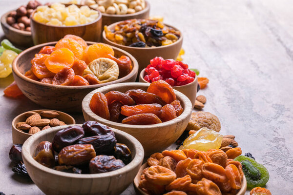 Dried fruits and nuts mix in a wooden bowl. Assortment of candied fruits. Judaic holiday Tu Bishvat. Copy space