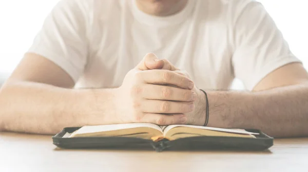 Reading the bible. Prayer. Hands folded in prayer concept. The concept of faith, spirituality and religion