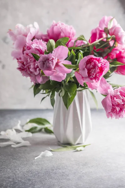 Fresh Peony flowers in vase. bouquet close up. Stylish floral greeting card.