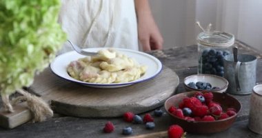 Kadın ahşap zemin üzerinde un ile ev yapımı hamur tatlısı ya da Pierogi yaptı. Geleneksel Ukrayna veya Polonya yemekleri.