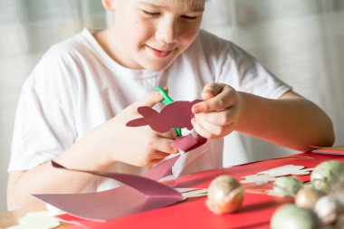 Paskalya tavşanları yapan çocuk, çocuklar ve ailesi için el işi yapan çocuk..