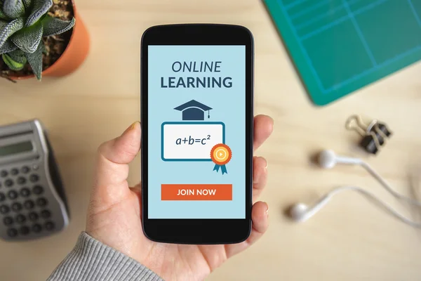 Hand holding smart phone with online learning concept on screen