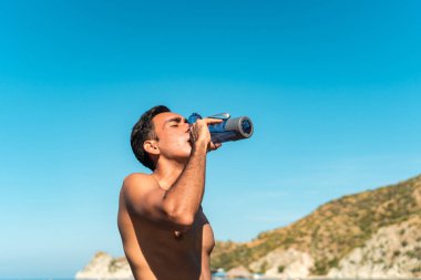 Koşucu dinleniyor, yazın sahilde su içiyor..