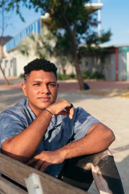 Kameraya bakan, ciddi, düşünceli ve yakışıklı bir Afro-Amerikan genç adamın portresi..