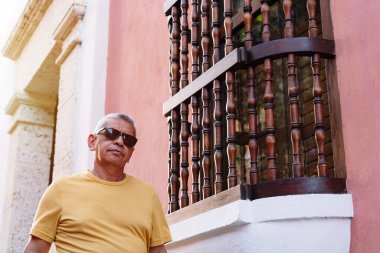 Elderly man standing on city street