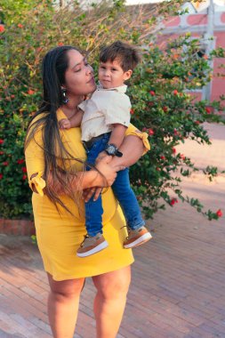 Bir anne sevgiyle ağlayan çocuğunu parkta tutar..