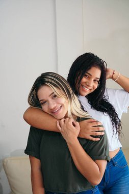 Two cute adorable friends posing with a smile on a white background