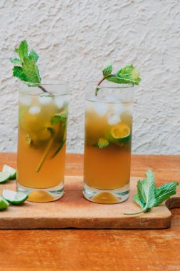 Limonlu mojito kokteyli ve tahta bir tahtanın üzerinde nane şekeri. Yaz içeceği.
