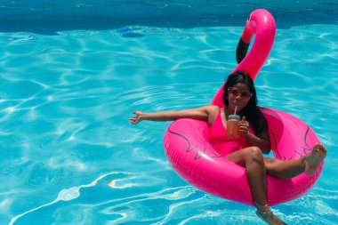 African girl in the pool relaxing in an inflatable