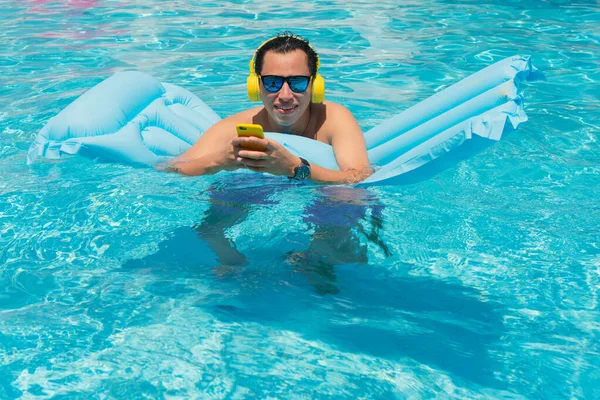 Caucasian Man Pool Headphones Cell Phone —  Fotos de Stock