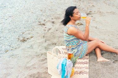 Güzel genç bayan bir bardak şarap içiyor.