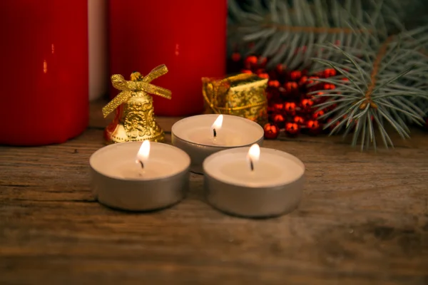 Three burning Christmas candles on the background of fir-tree br — Stock Photo, Image