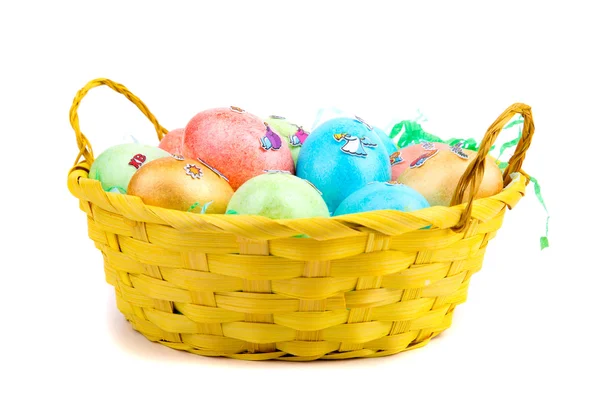 Multicolored Easter eggs in a basket — Stock Photo, Image