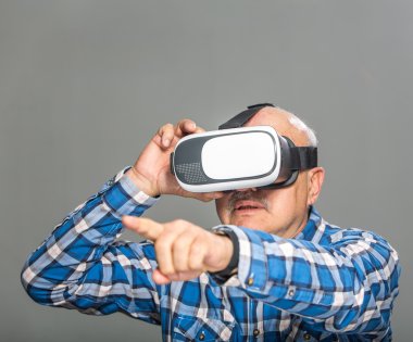 Old man in virtual reality glasses have fun clipart