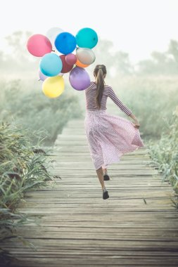 Beautiful woman with colorful balloons clipart