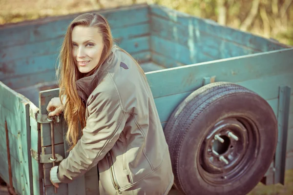 Young farmer with agricultural trailer — Stock Photo, Image