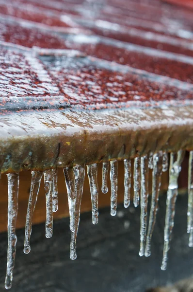 Icicles hanging down from a roof — Stock Photo, Image