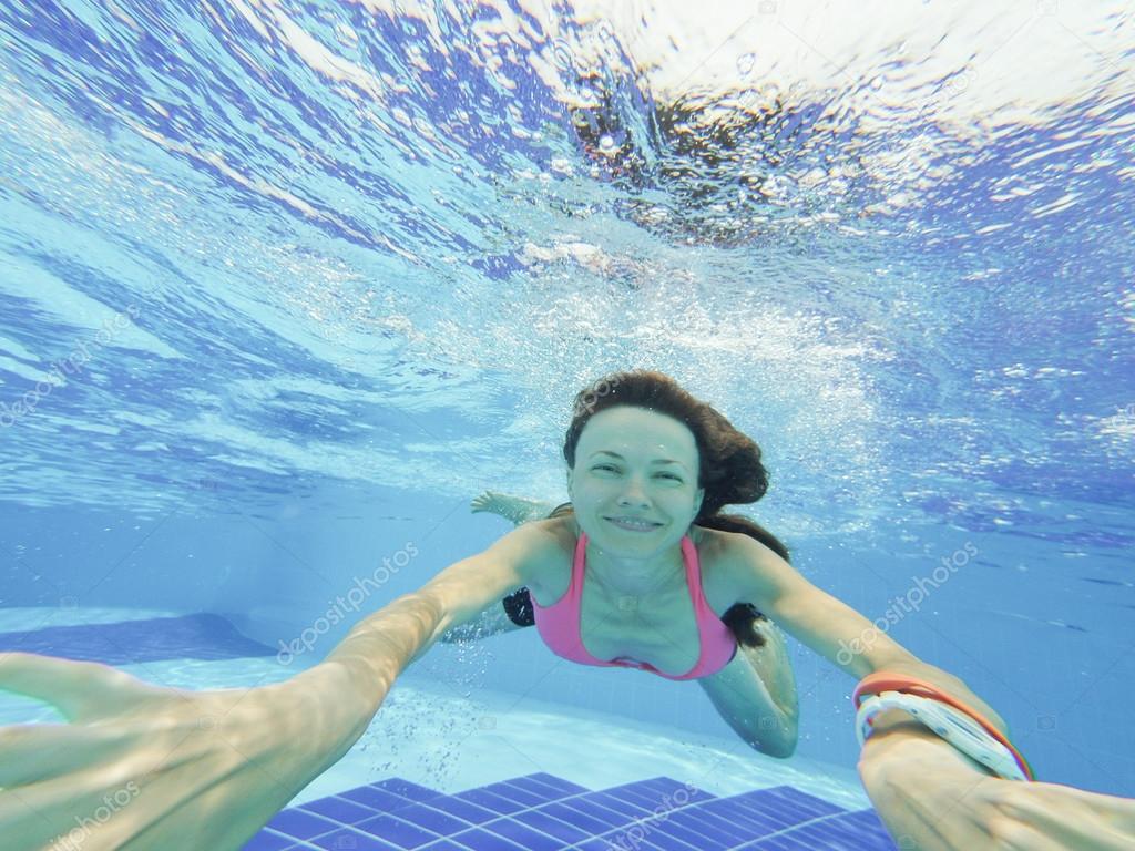 Woman Swimming Underwater In Pool Smiling Stock Photo By Peppersmint