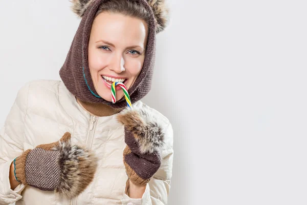 Beautiful woman holding christmas lollipop — Stock Photo, Image