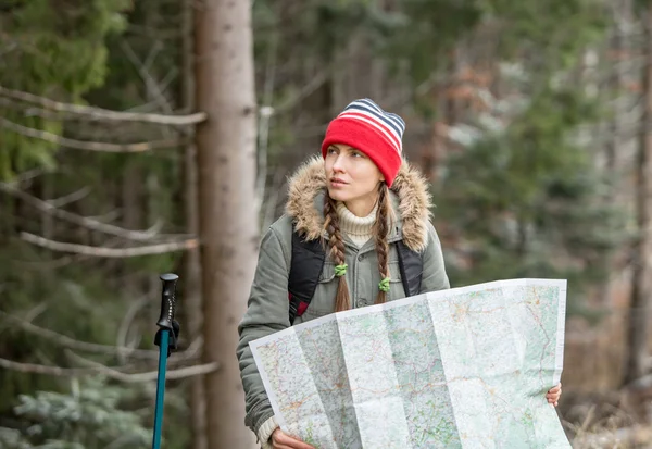 Piesze wycieczki kobieta z plecaka w jesienią lub zimą natura gospodarstwo mapę — Zdjęcie stockowe