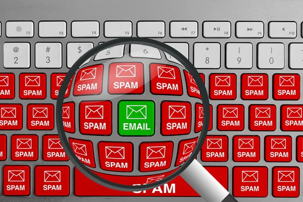 Computer keyboard with single green email button surrounded with red spam email buttons