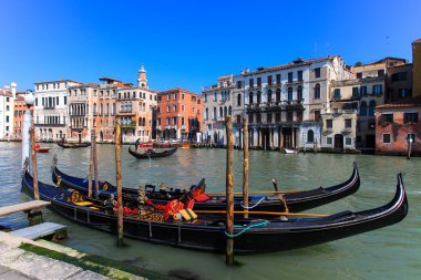 Venice, Italy - March 17, 2016: Traditional Gondolas at Venice grand canal. The Gondola is a traditional, flat-bottomed Venetian rowing boat, well suited to the conditions of the Venetian lagoon
