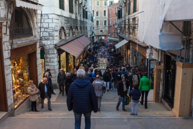 Venice, Italy - March 17 2016: Typical Piazza or Campo in the heart of venice, with shops, typical venetian architecture and tourists passing by