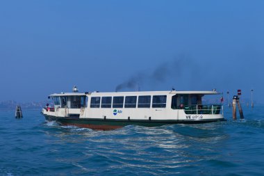 Venice, Italy - March 19, 2016: Vaporetto (water bus) at Venice canal. Vaporettos are a traditional, flat-bottomed Venetian motor boat, well suited to the conditions of the Venetian lagoon